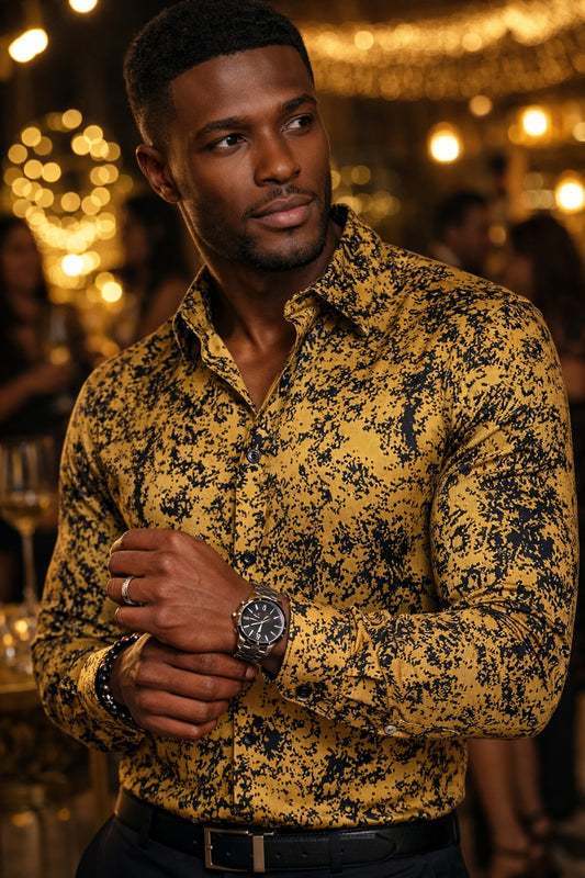 Man wearing a yellow patterned mandela shirt with a blurred background